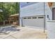 View of the garage, side patio, and covered carport at 631 Linfield Dr, Durham, NC 27701
