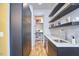 Hallway with modern cabinetry, shelves, and a sink, with plenty of storage space at 631 Linfield Dr, Durham, NC 27701