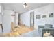 Bright hallway with light wood floors, modern lighting, and a cozy seating area at 631 Linfield Dr, Durham, NC 27701