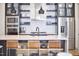 Modern kitchen with a quartz countertop island, stainless steel appliances, and open shelving at 631 Linfield Dr, Durham, NC 27701