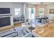 Open-concept living and dining area with hardwood floors, fireplace, and modern furnishings at 631 Linfield Dr, Durham, NC 27701