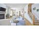 Spacious living room with a fireplace, open staircase, and modern decor at 631 Linfield Dr, Durham, NC 27701