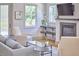 Bright living room featuring a fireplace, hardwood floors, and stylish decor at 631 Linfield Dr, Durham, NC 27701