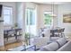 Open-concept living and dining area with large windows, modern lighting, and stylish furnishings at 631 Linfield Dr, Durham, NC 27701