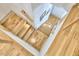 Modern staircase design with wooden steps, cable railing, and natural light streaming, connecting the home's levels at 631 Linfield Dr, Durham, NC 27701
