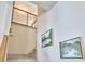 Elegant staircase with wood railing and decorative wall art enhancing the home's aesthetic appeal at 631 Linfield Dr, Durham, NC 27701