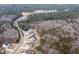 Aerial view of community showing houses nestled within wooded lots and winding streets at 642 The Parks Dr, Pittsboro, NC 27312
