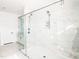This bathroom showcases a seamless glass shower with a dual shower head system and pristine white marble tiling at 642 The Parks Dr, Pittsboro, NC 27312