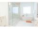 Bright bathroom with a walk-in shower, soaking tub, and modern fixtures for a relaxing retreat at 642 The Parks Dr, Pittsboro, NC 27312