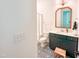 Stylish bathroom featuring a walk-in shower, a patterned tile floor, and a modern vanity with an arched mirror at 642 The Parks Dr, Pittsboro, NC 27312