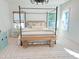 Serene bedroom with a four-poster bed, neutral decor, and soft lighting, creating a relaxing retreat at 642 The Parks Dr, Pittsboro, NC 27312
