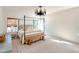 Charming bedroom showcasing a four-poster bed, light-colored walls, and coordinating furniture for a tranquil space at 642 The Parks Dr, Pittsboro, NC 27312