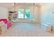 Bright bonus room features stylish hanging chairs by a window, a pink couch and charming built-in shelving at 642 The Parks Dr, Pittsboro, NC 27312