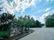 Stone community entrance with mature trees and landscaping on a beautiful day with blue sky at 642 The Parks Dr, Pittsboro, NC 27312