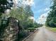 Gated entrance to a beautiful community with stone accents and lush landscaping under a blue sky at 642 The Parks Dr, Pittsboro, NC 27312