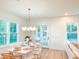 Dining room boasts natural light, a modern light fixture, and ample seating, perfect for Gathering gatherings at 642 The Parks Dr, Pittsboro, NC 27312