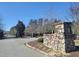 Stone entrance to community with well-maintained landscaping at 642 The Parks Dr, Pittsboro, NC 27312