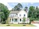 Beautiful two-story home with lush landscaping and a well-maintained lawn at 642 The Parks Dr, Pittsboro, NC 27312
