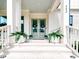 Elegant entryway with double doors, fern planters, and stylish details at 642 The Parks Dr, Pittsboro, NC 27312