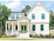 Charming two-story home featuring a welcoming front porch and lush landscaping at 642 The Parks Dr, Pittsboro, NC 27312