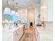 Bright kitchen features a large island, stainless steel appliances, and white cabinets for ample storage space at 642 The Parks Dr, Pittsboro, NC 27312