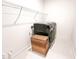 Bright laundry room features modern washer and dryer with a storage basket and wire shelving for convenience at 642 The Parks Dr, Pittsboro, NC 27312