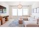 Inviting living room with a plush sectional sofa, stylish lighting, and large windows for natural light at 642 The Parks Dr, Pittsboro, NC 27312