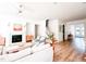 Open living room features a fireplace, comfortable seating and abundant natural light through large windows at 642 The Parks Dr, Pittsboro, NC 27312