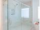 Luxurious walk-in shower featuring glass enclosure, marble tile, and built-in niches for toiletries at 642 The Parks Dr, Pittsboro, NC 27312