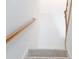 Carpeted staircase featuring a wooden handrail and white walls, leading to the upper level of the home at 642 The Parks Dr, Pittsboro, NC 27312