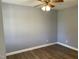 Cozy bedroom showcasing wood-look flooring, natural light, and fresh, neutral paint at 703 W Church St, Angier, NC 27501