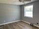 Bedroom features hard-wood flooring, a ceiling fan, and a window for sunlight at 703 W Church St, Angier, NC 27501