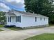 Exterior view of the property with white siding, showing the driveway and backyard at 703 W Church St, Angier, NC 27501