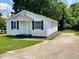 Charming single-story home with white siding, blue shutters, and a well-maintained front yard at 703 W Church St, Angier, NC 27501