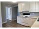 Kitchen featuring white appliances, laminate countertop, and hardwood floors at 703 W Church St, Angier, NC 27501