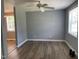 The living room features gray walls, wood flooring, and a ceiling fan for comfort at 703 W Church St, Angier, NC 27501