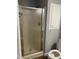 Shower with glass doors, gray walls, and a white storage cabinet to the right of the shower at 703 W Church St, Angier, NC 27501