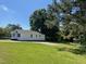 Exterior view of the house showing the large green yard and driveway at 703 W Church St, Angier, NC 27501