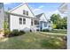 Well-maintained backyard with lush lawn, pathway, and the exterior of the home with a screened in porch at 706 Great Ridge Pkwy, Chapel Hill, NC 27516