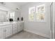 Bright bathroom featuring a double vanity, neutral paint, natural light, and a glass enclosed shower at 706 Great Ridge Pkwy, Chapel Hill, NC 27516