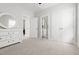Bedroom with neutral carpet, white walls, ensuite bath and walk-in closets at 706 Great Ridge Pkwy, Chapel Hill, NC 27516
