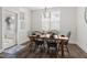 Cozy dining room with wood table, black chairs, chandelier, and plenty of natural light from windows and door at 706 Great Ridge Pkwy, Chapel Hill, NC 27516