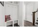 Entryway with a built-in bench and storage, hooks, dark wood floors, and access to the staircase at 706 Great Ridge Pkwy, Chapel Hill, NC 27516