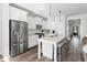 Bright kitchen with stainless steel appliances, white cabinets, and large center island with barstool seating at 706 Great Ridge Pkwy, Chapel Hill, NC 27516