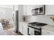 Bright kitchen featuring white cabinets and stainless steel appliances at 706 Great Ridge Pkwy, Chapel Hill, NC 27516