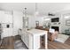 Open concept kitchen flowing into the living area, with a large island and modern appliances at 706 Great Ridge Pkwy, Chapel Hill, NC 27516
