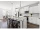 Modern kitchen with white cabinets, stainless steel appliances, and stylish island with seating at 706 Great Ridge Pkwy, Chapel Hill, NC 27516