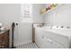 Laundry room with new washer and dryer, white cabinets, patterned floors, and natural light at 706 Great Ridge Pkwy, Chapel Hill, NC 27516