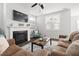 Inviting living room featuring a fireplace, ceiling fan, comfortable seating, and ample natural light at 706 Great Ridge Pkwy, Chapel Hill, NC 27516