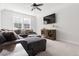 Cozy living room featuring a large sectional, mounted TV, ceiling fan, and lots of natural light at 706 Great Ridge Pkwy, Chapel Hill, NC 27516